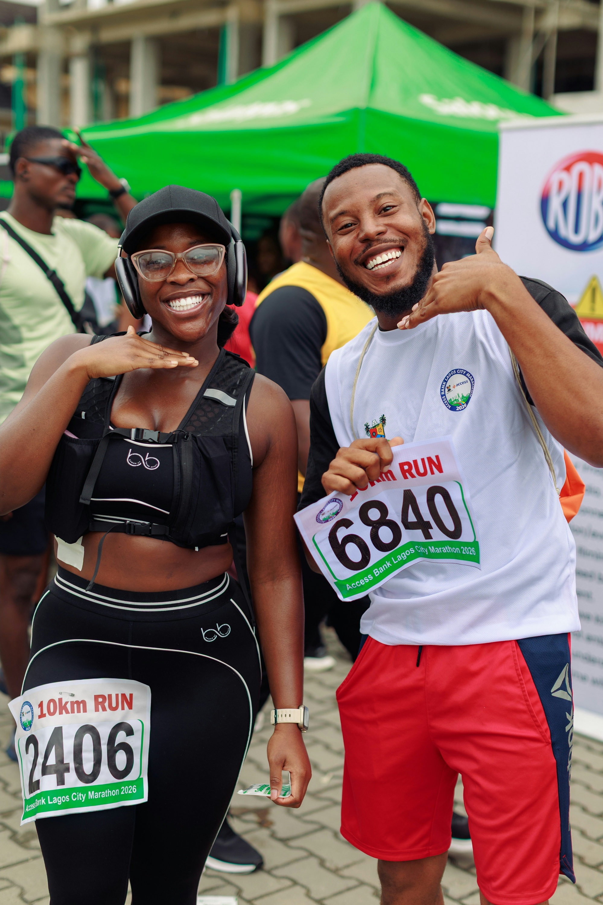 Happy couple smiling while running a marathon together
